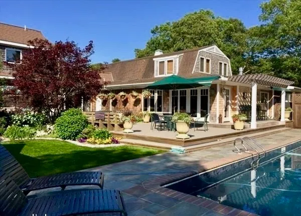 a front view of a house with yard and green space