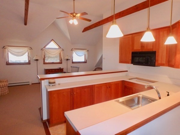 17 Otis Bassett Road West Tisbury, MA 02568 - Photo 11 of 28 a kitchen with a sink a counter top space and a lamp