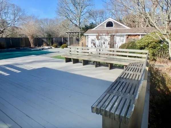 a view of a house with wooden deck front of house