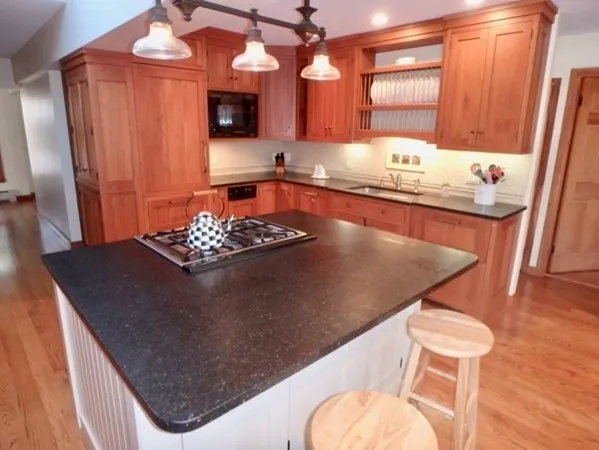 a kitchen with a table chairs and a refrigerator