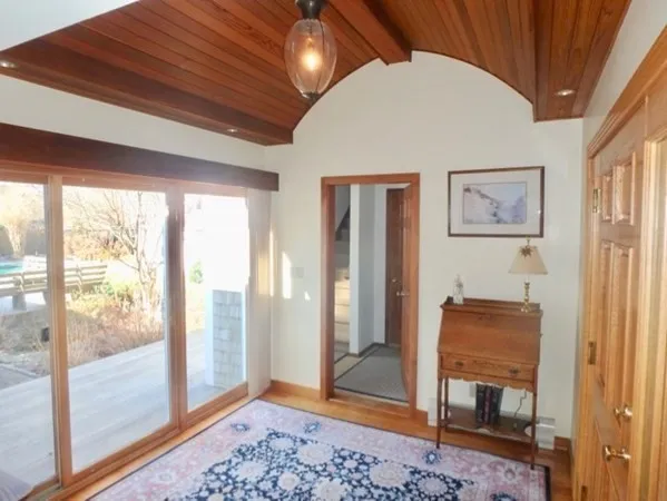 a view of room with a large window and front door