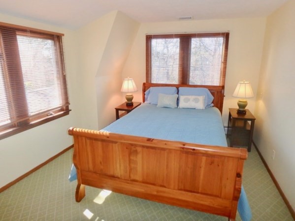 17 Otis Bassett Road West Tisbury, MA 02568 - Photo 9 of 28 a bed sitting in a bedroom next to a window