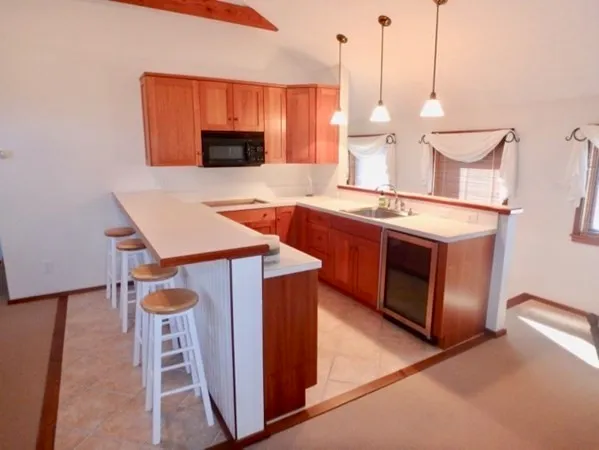 a kitchen with stainless steel appliances wooden floor sink and stove