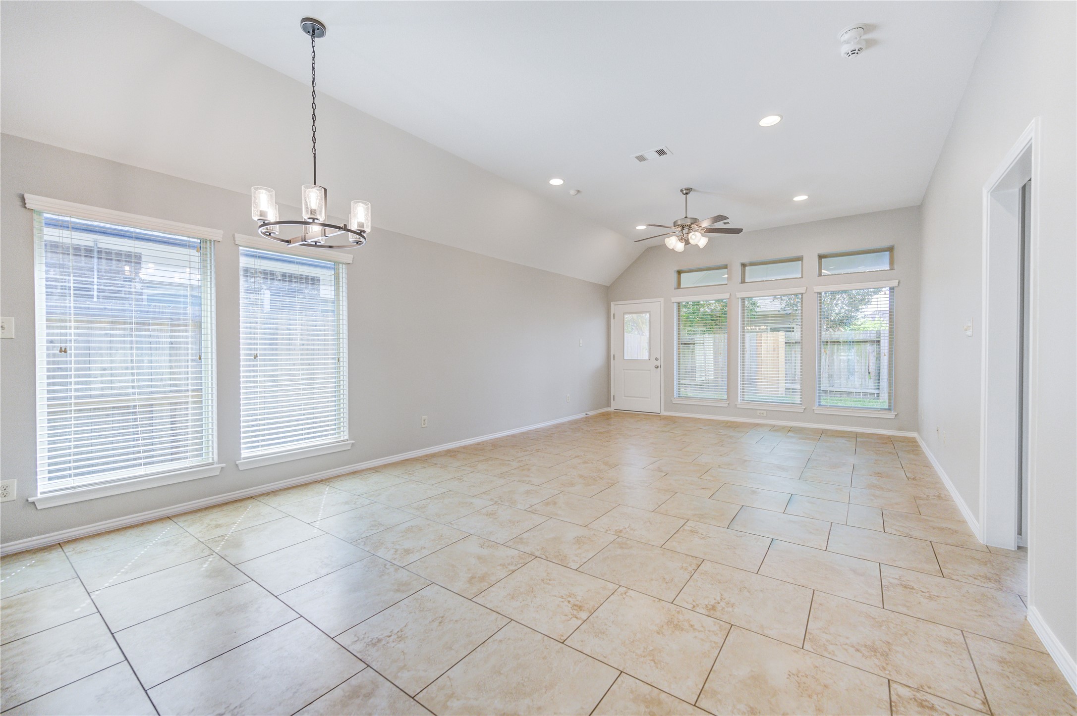 27407 Gatlin Lane Spring, TX 77386 - Photo 16 of 35 The expansive family room is designed for comfortable everyday living with soaring ceilings, abundant natural light, and a seamless connection to the kitchen. The generous layout provides endless possibilities for furniture arrangement while maintaining an open and airy feel.