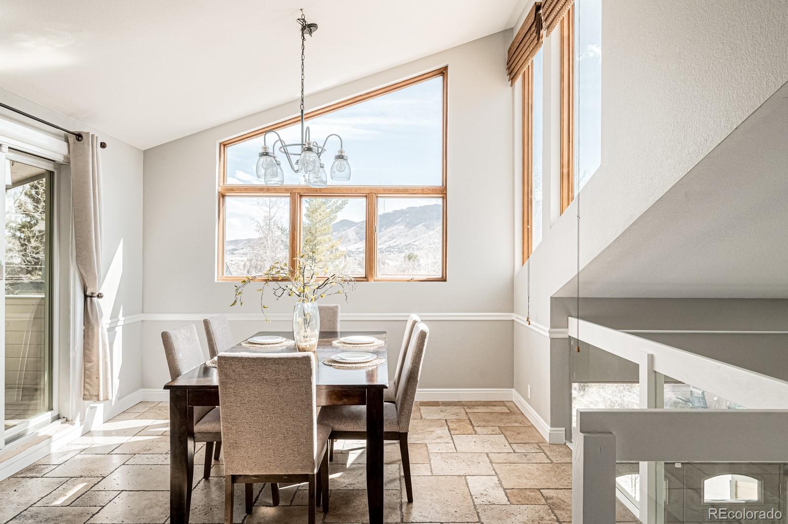 620 Cascade Drive Golden, CO 80403 - Photo 15 of 31 a dining room with furniture a chandelier and a rug