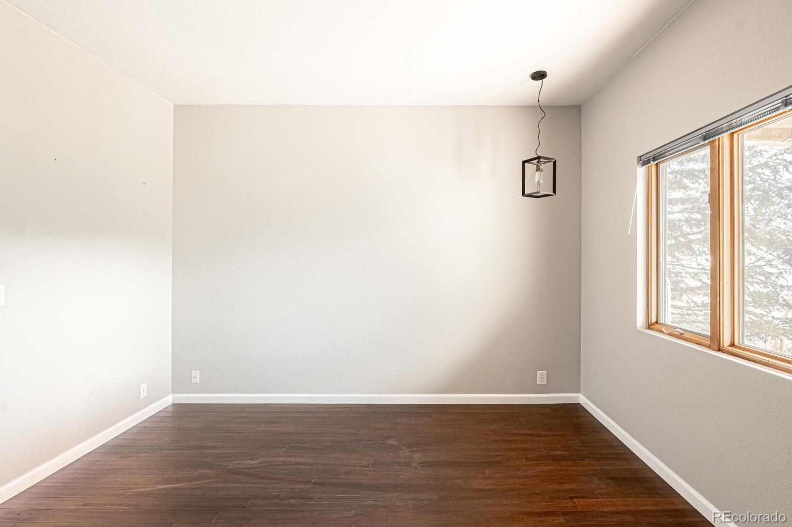 620 Cascade Drive Golden, CO 80403 - Photo 27 of 31 an empty room with wooden floor and windows