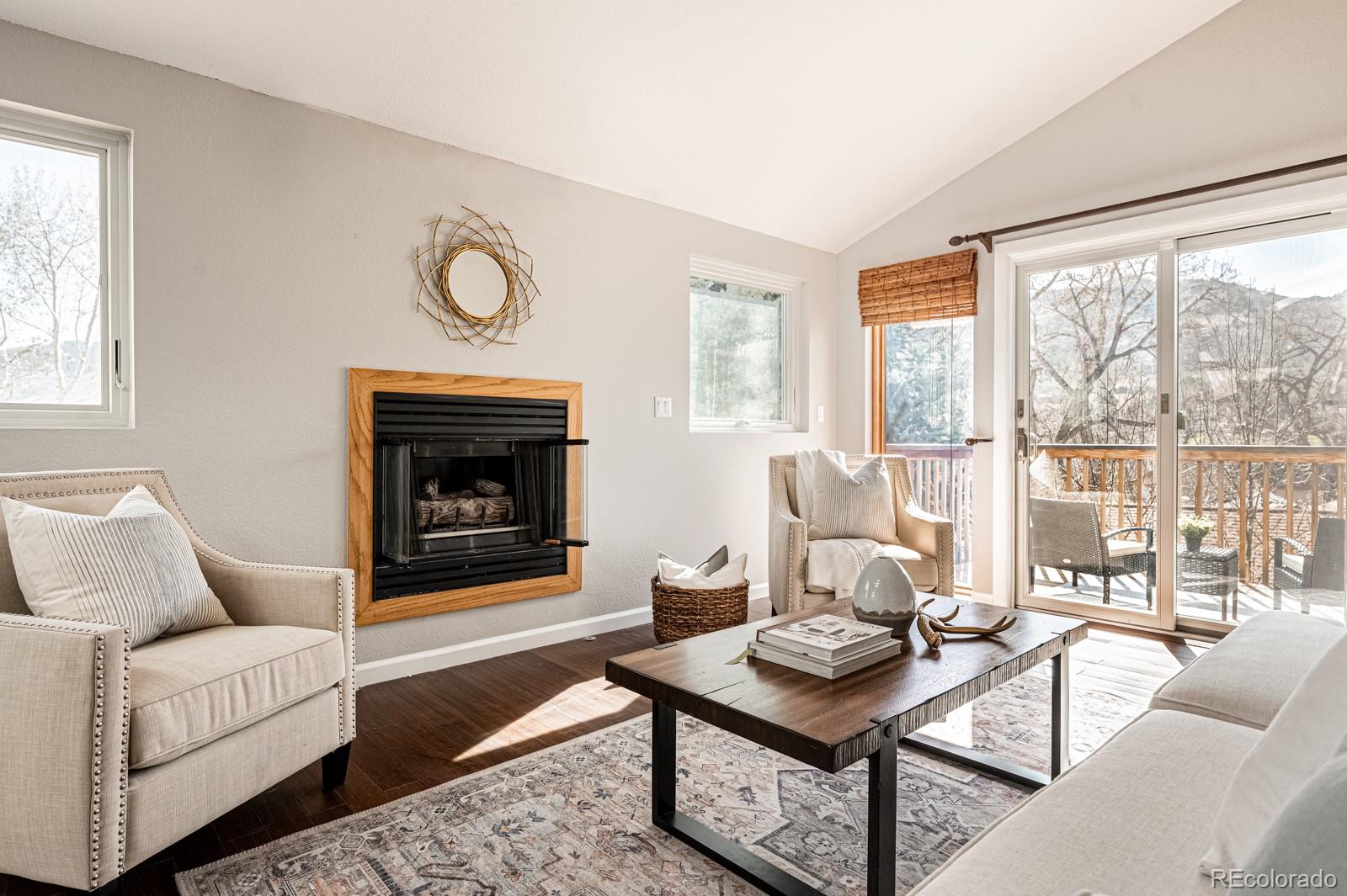 620 Cascade Drive Golden, CO 80403 - Photo 7 of 31 a living room with furniture a fireplace and large windows