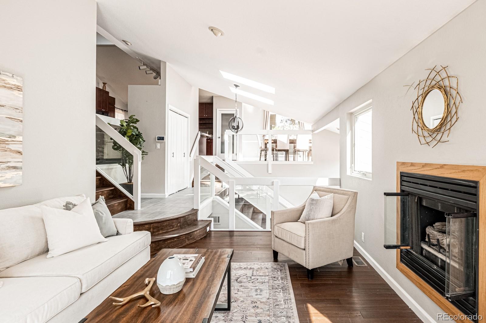 620 Cascade Drive Golden, CO 80403 - Photo 10 of 31 a living room with furniture a flat screen tv and a fireplace