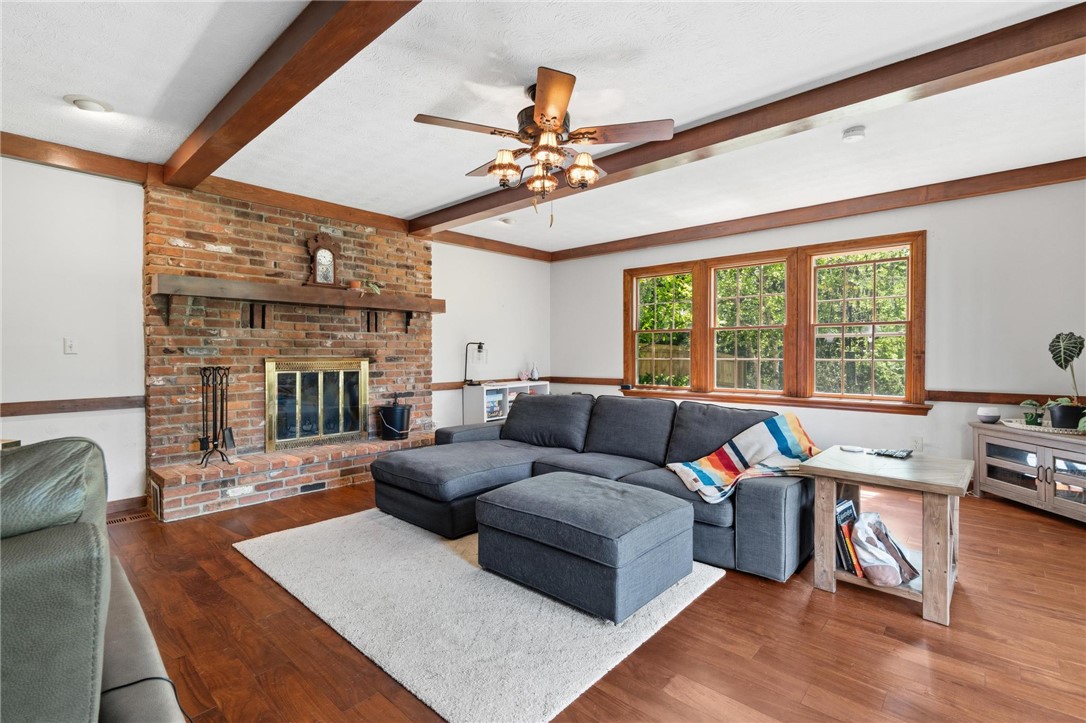 10168 Atchison Road Dayton, OH 45458 - Photo 30 of 44 This living room offers rich hardwood floors, an inviting fireplace, and a bright view of the outdoors.