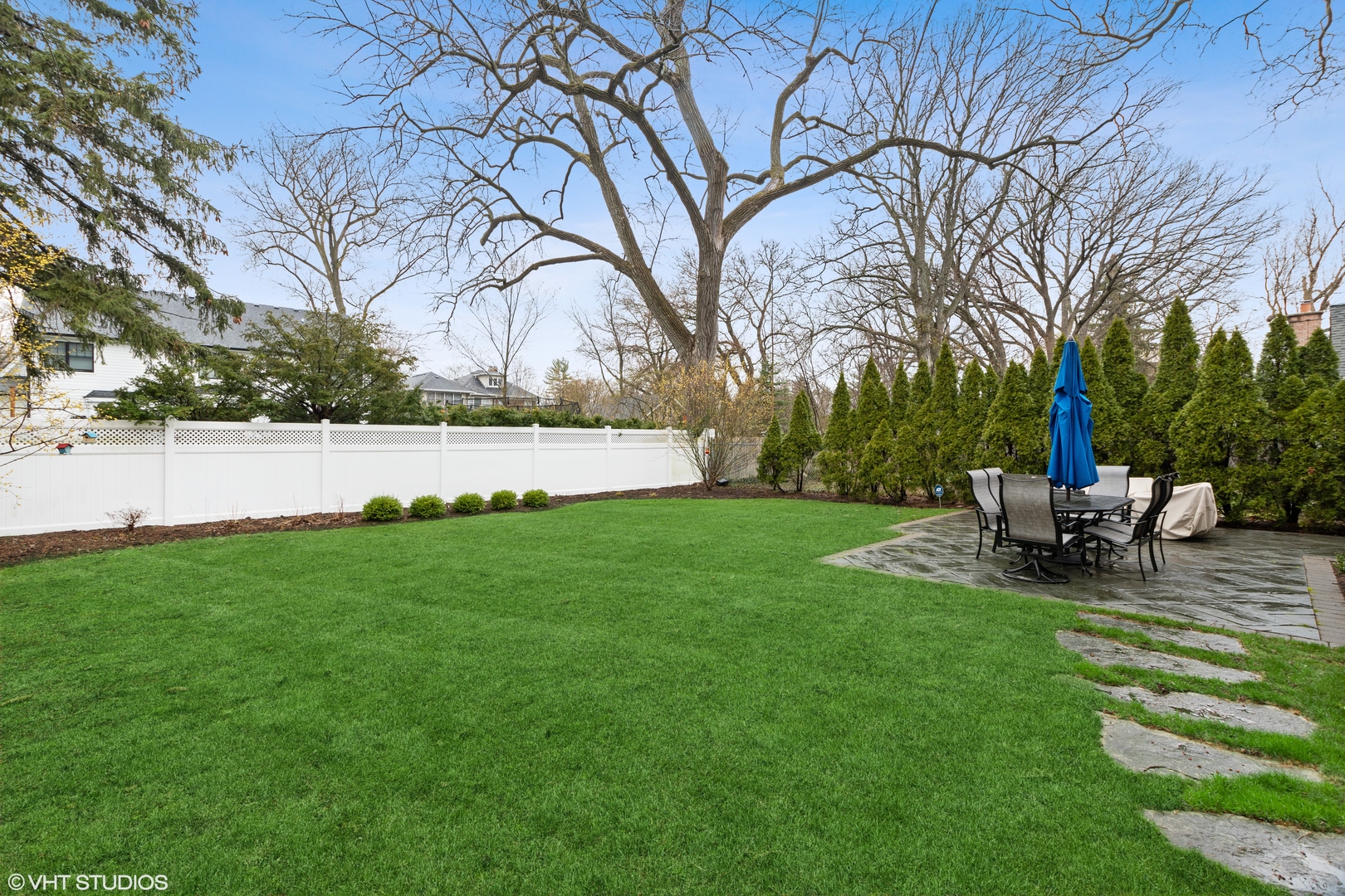 1041 Pontiac Road Wilmette, IL 60091 - Photo 29 of 33 a view of a backyard with lawn chairs and a fire pit