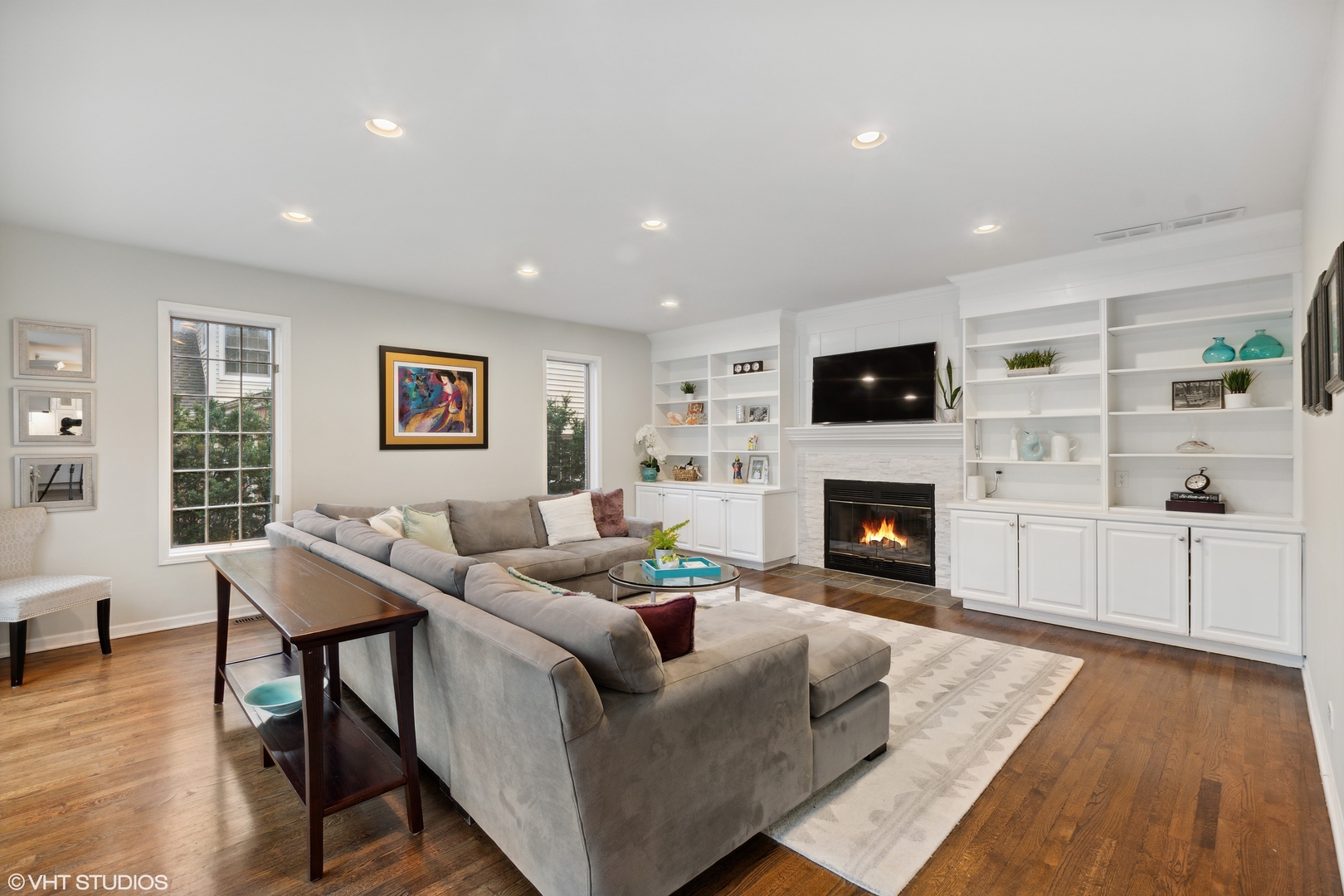 1041 Pontiac Road Wilmette, IL 60091 - Photo 10 of 33 a living room with furniture a fireplace and a flat screen tv