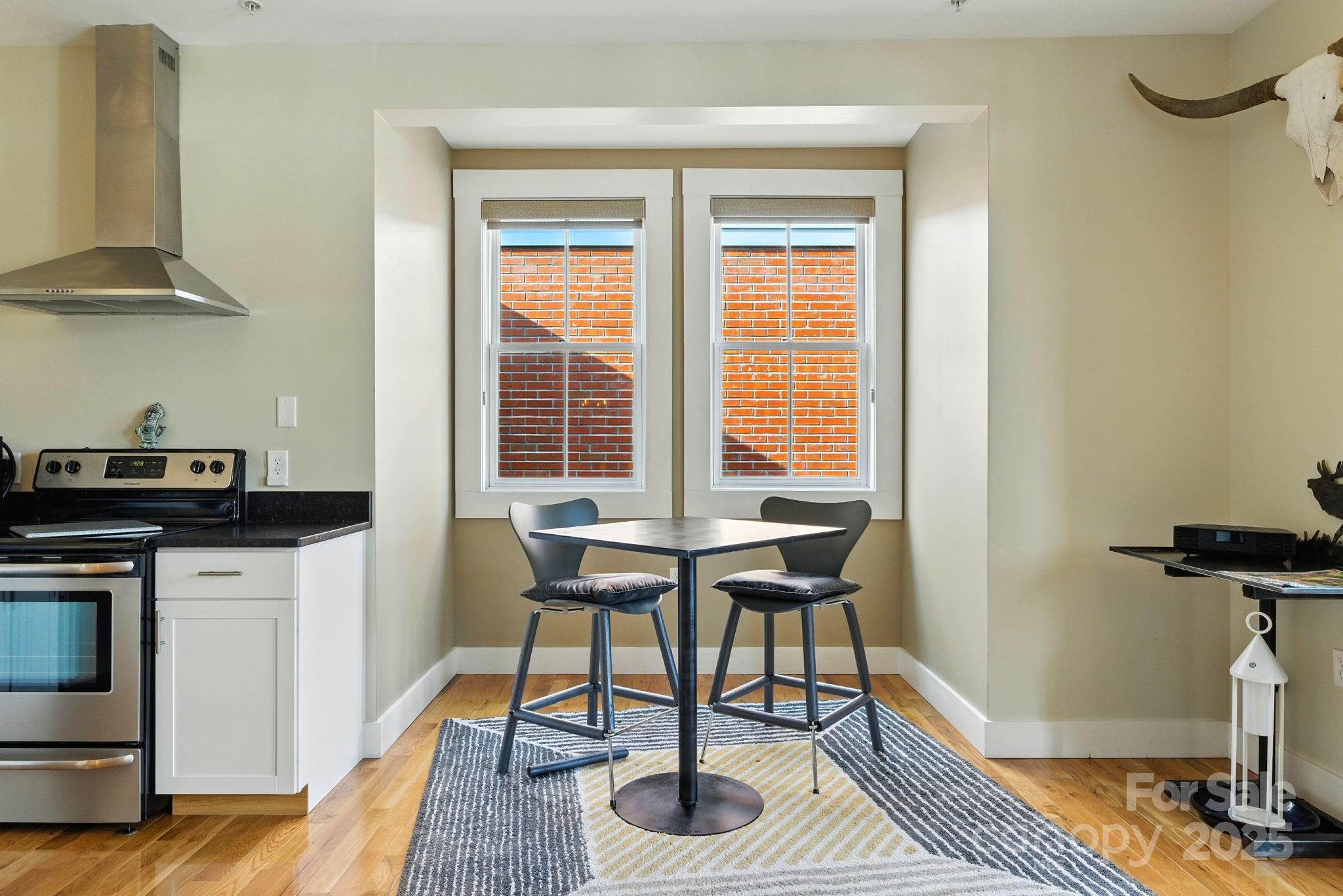 23 South Broad Street Brevard, NC 28712 - Photo 17 of 30 a kitchen with stainless steel appliances granite countertop a stove a sink and a microwave