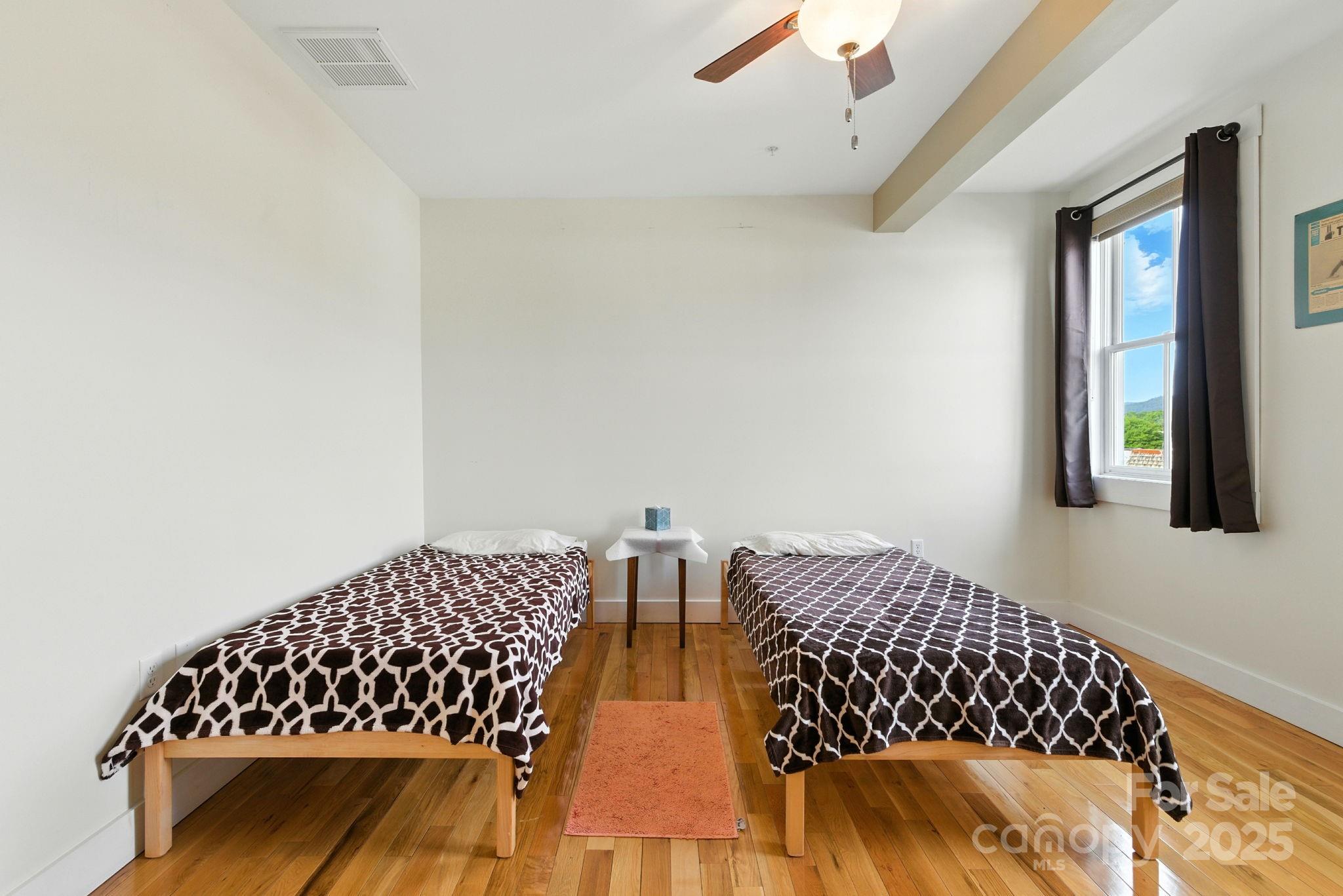 23 South Broad Street Brevard, NC 28712 - Photo 21 of 30 a bedroom with bed and a window