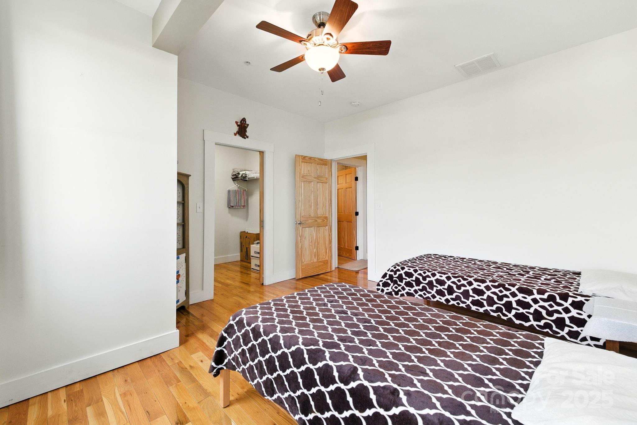 23 South Broad Street Brevard, NC 28712 - Photo 22 of 30 a bedroom with a bed and dresser