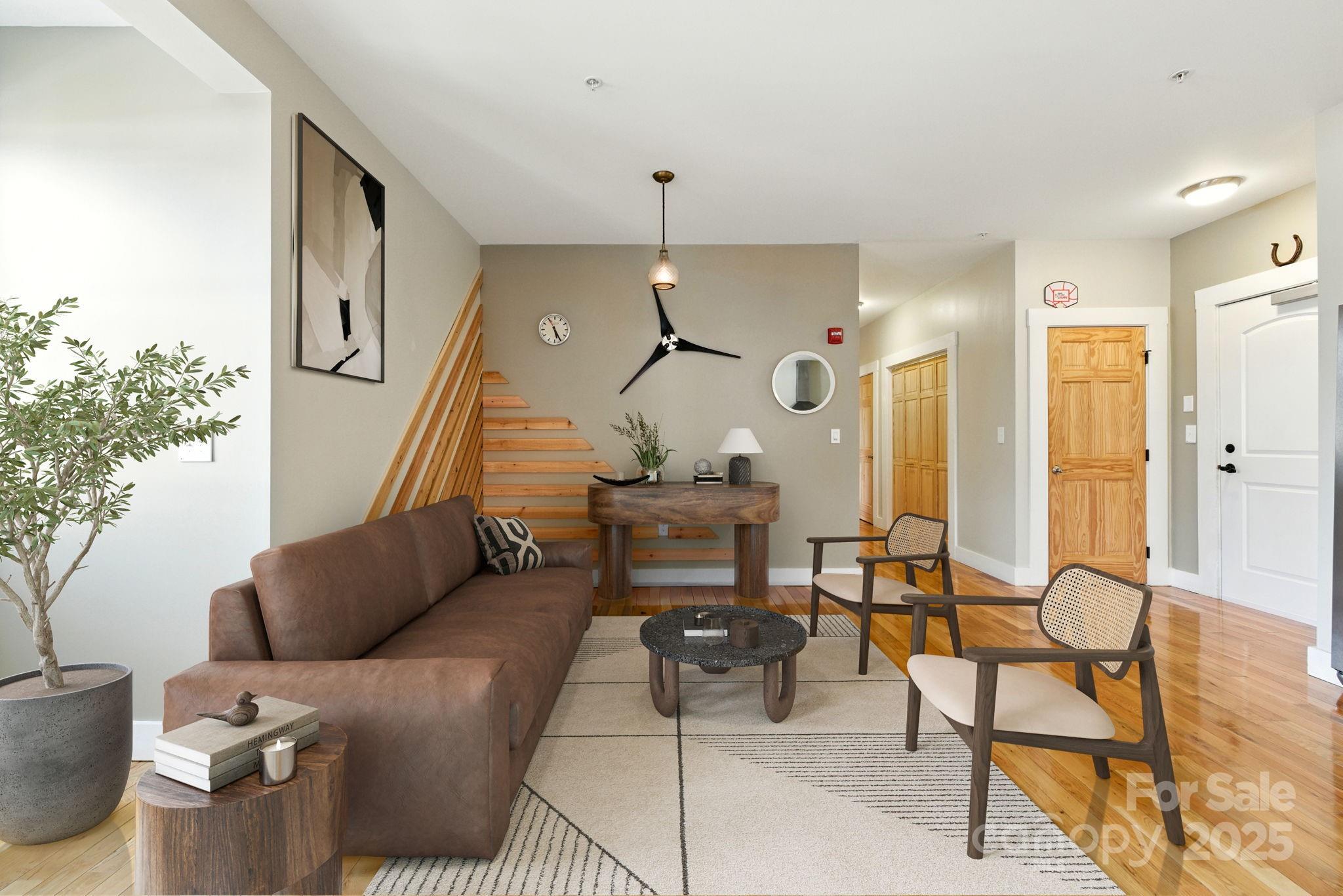 23 South Broad Street Brevard, NC 28712 - Photo 7 of 30 a living room with furniture and a chandelier