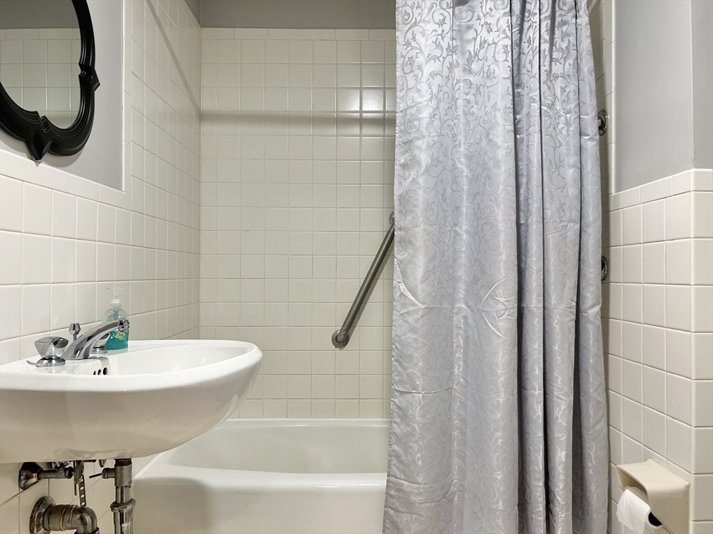 13 Princeton Street, Unit 2 Somerville, MA 02144 - Photo 5 of 9 a bathroom with a sink and a mirror