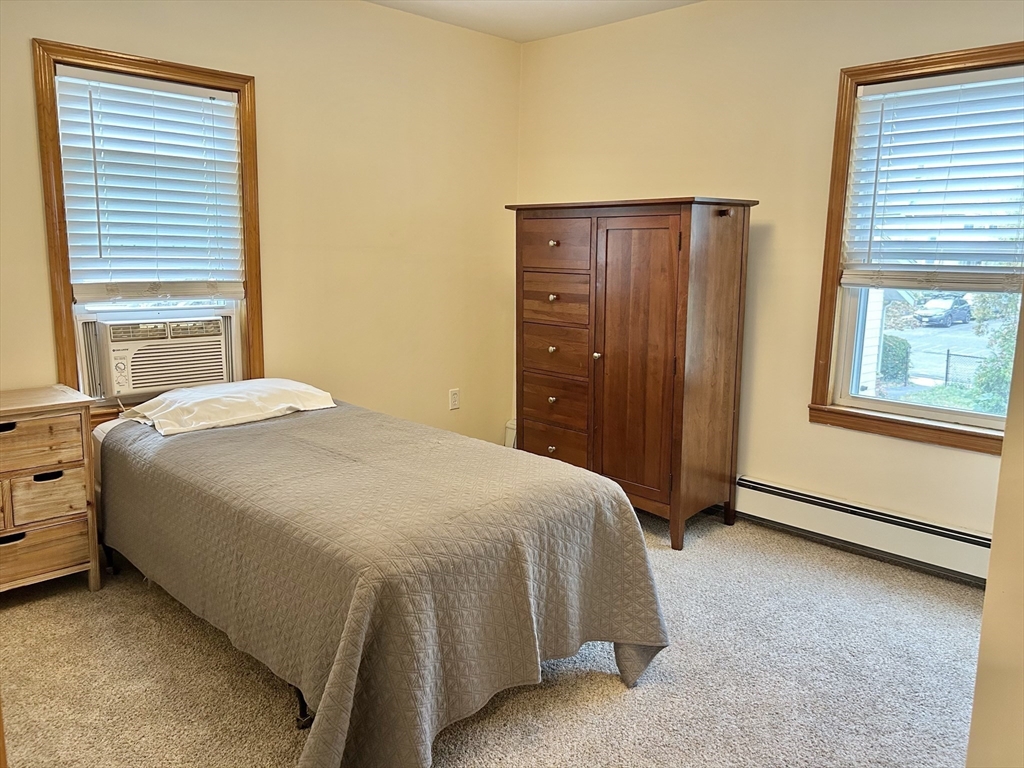 13 Princeton Street, Unit 2 Somerville, MA 02144 - Photo 7 of 9 a bedroom with a bed and a window