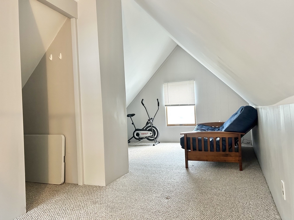 13 Princeton Street, Unit 2 Somerville, MA 02144 - Photo 9 of 9 a living room with furniture gym equipment and a chandelier