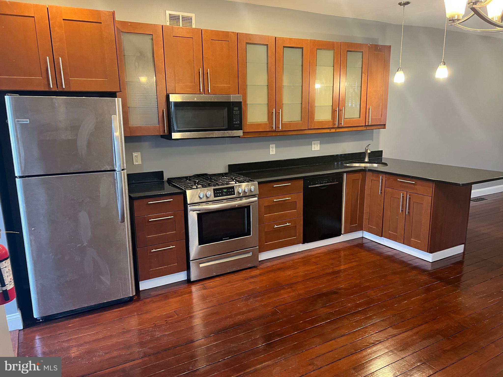 102 3rd Avenue Roebling, NJ 08554 - Photo 1 of 8 a kitchen with granite countertop wooden floors and stainless steel appliances