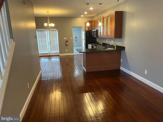 a view of kitchen with cabinets and wooden floor