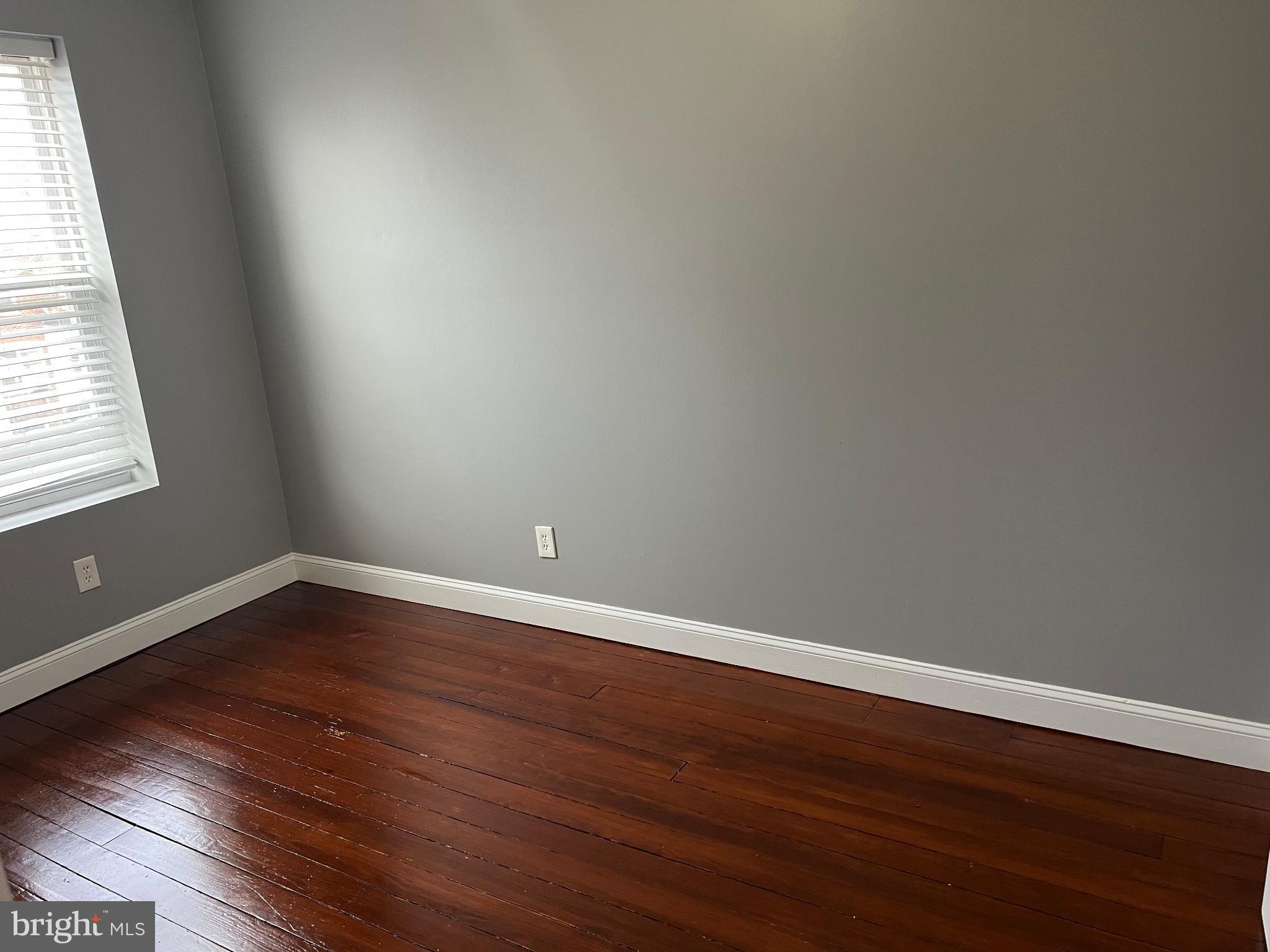102 3rd Avenue Roebling, NJ 08554 - Photo 5 of 8 a view of an empty room with wooden floor and a window