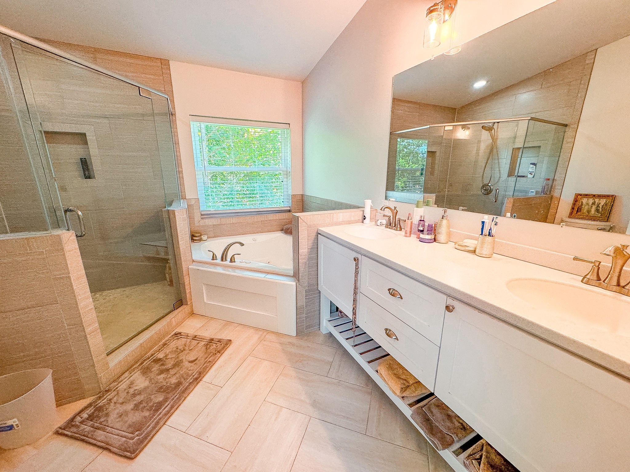 4042 Jones Hollow Road Lobelville, TN 37097 - Photo 13 of 30 a bathroom with a double vanity sink a toilet a mirror and shower