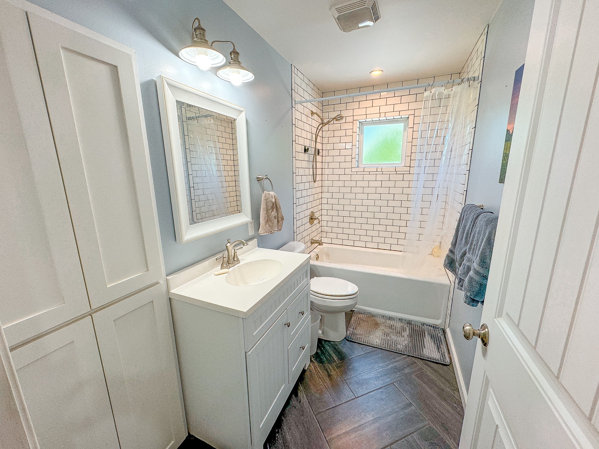 4042 Jones Hollow Road Lobelville, TN 37097 - Photo 20 of 30 a bathroom with a sink a toilet a mirror and shower