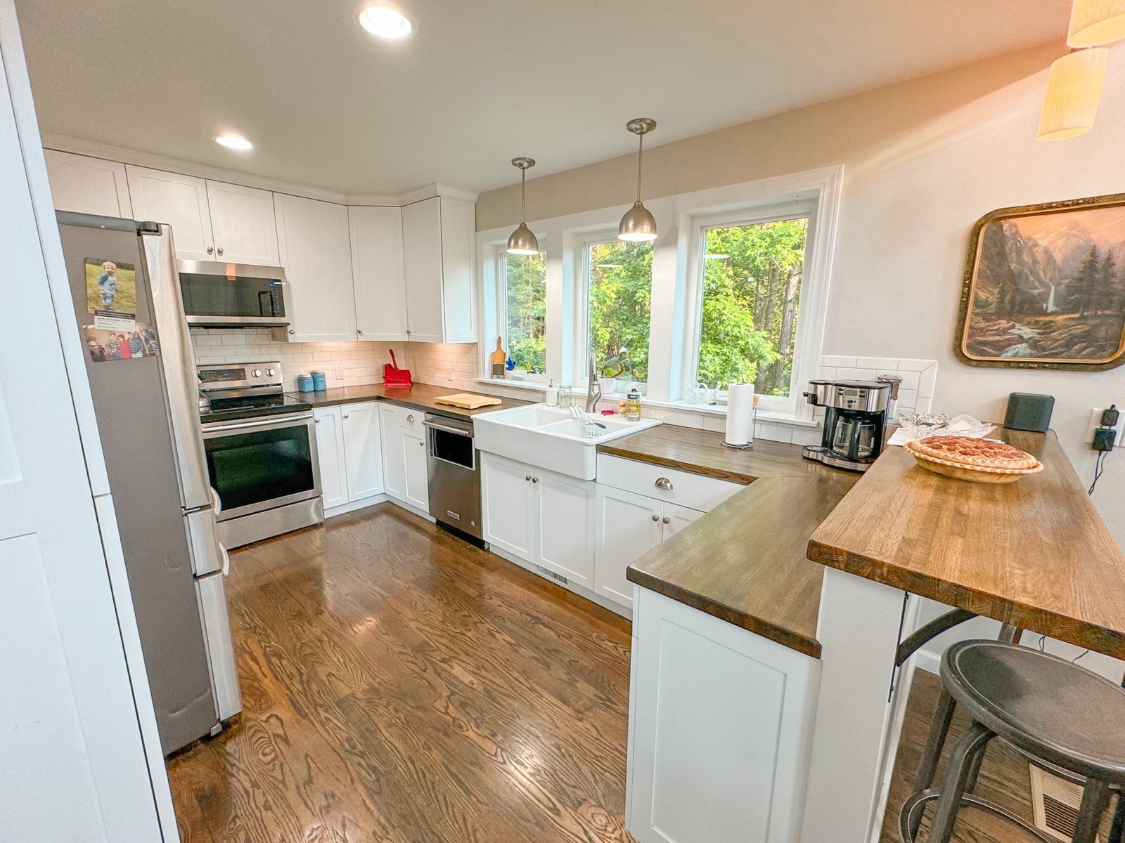 4042 Jones Hollow Road Lobelville, TN 37097 - Photo 3 of 30 a kitchen with stainless steel appliances a stove a sink dishwasher a refrigerator and a stove with wooden floor