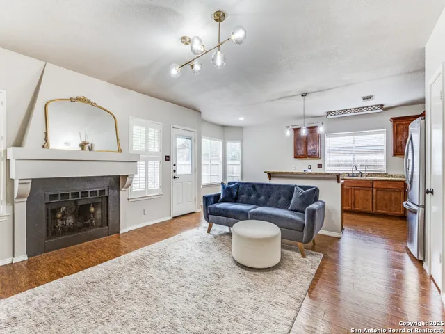 a living room with furniture and a fireplace