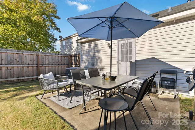 a view of a backyard with sitting area