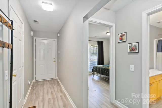 a view of a hallway view with wooden floor and living room