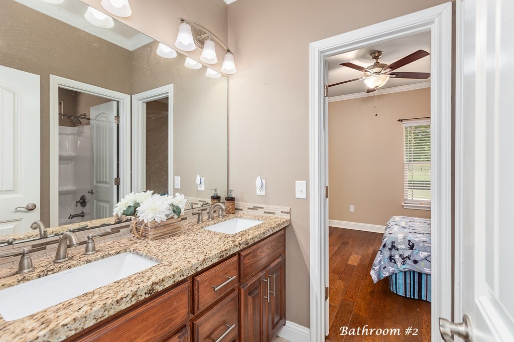1171 Old Ewing Road Lufkin, TX 75901 - Photo 23 of 49 a bathroom with a granite countertop sink and a mirror
