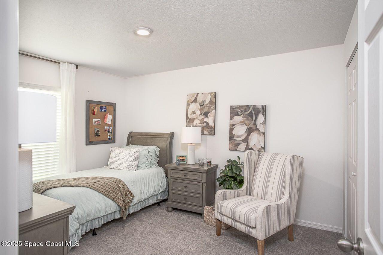 592 Plumbago Road Northwest Palm Bay, FL 32907 - Photo 16 of 20 a bedroom with a bed chair and couch