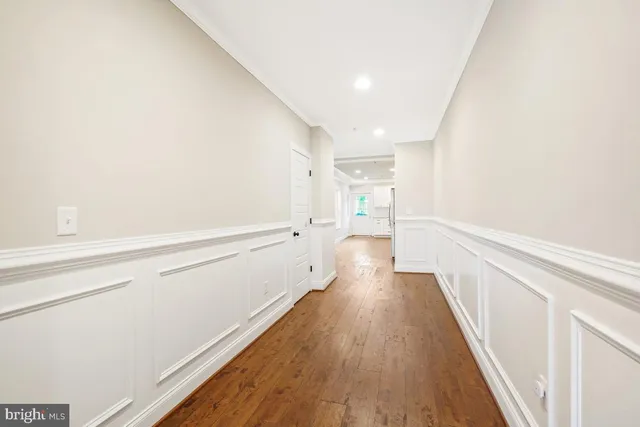 a view of kitchen with wooden floor and electronic appliances