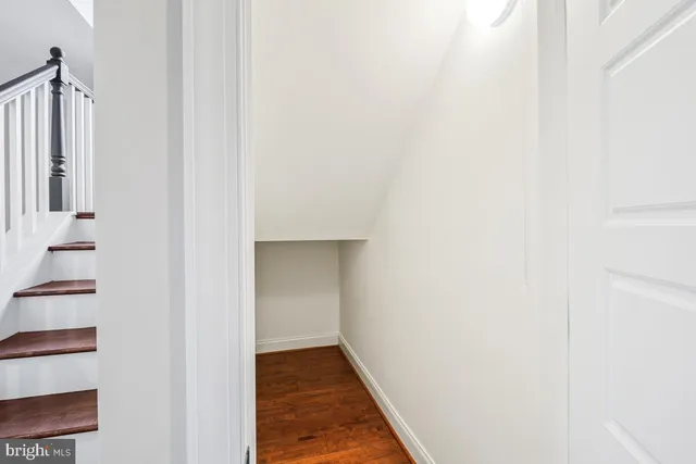 an empty room with a ceiling fan and window