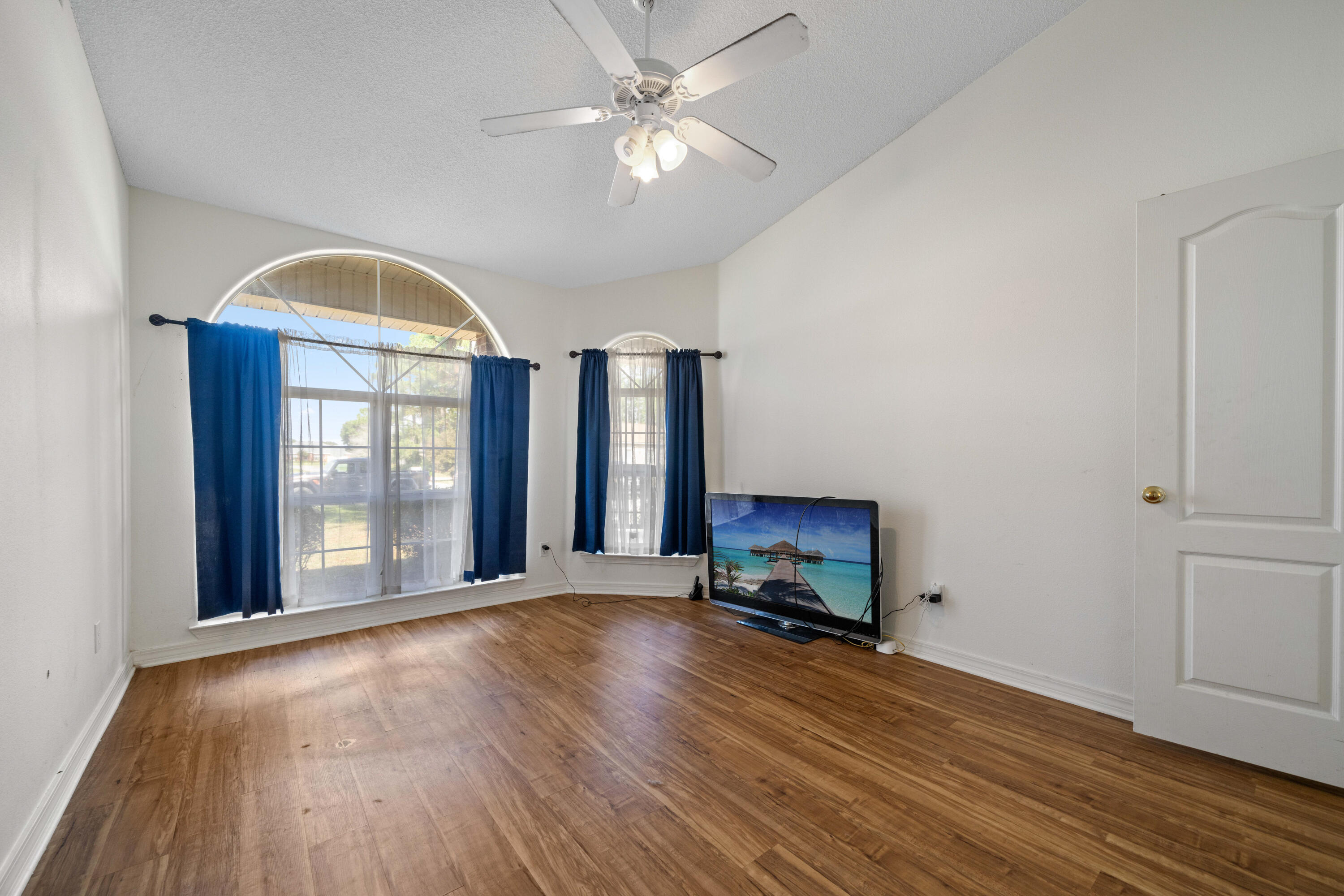 7199 Riverview Road Navarre, FL 32566 - Photo 12 of 15 a view of an empty room with a window and wooden floor