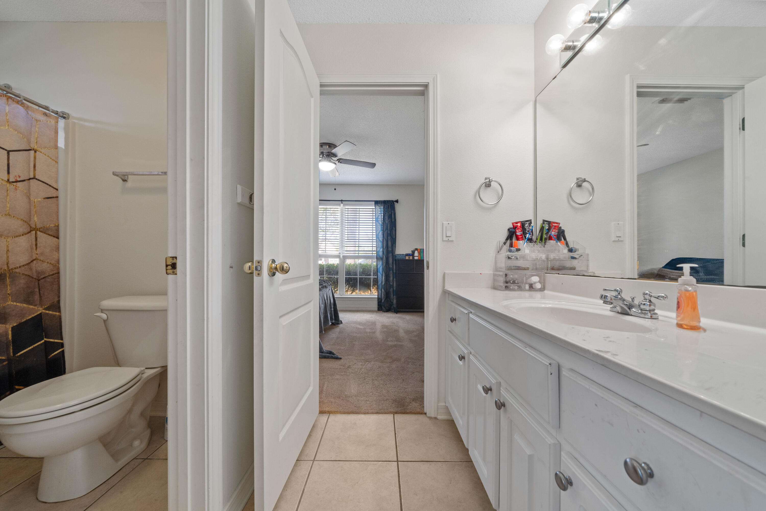 7199 Riverview Road Navarre, FL 32566 - Photo 14 of 15 a bathroom with a sink a toilet and shower