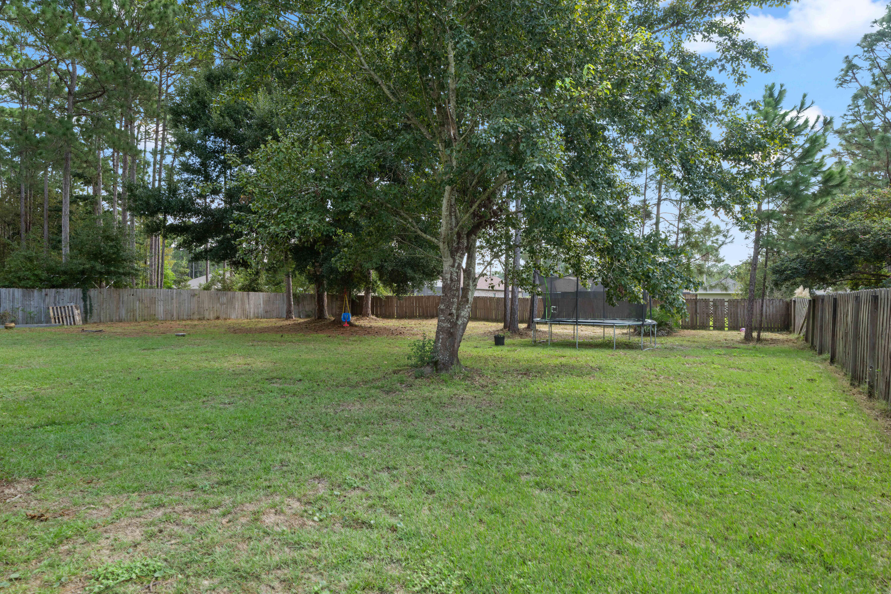 7199 Riverview Road Navarre, FL 32566 - Photo 4 of 15 a view of outdoor space with deck and yard