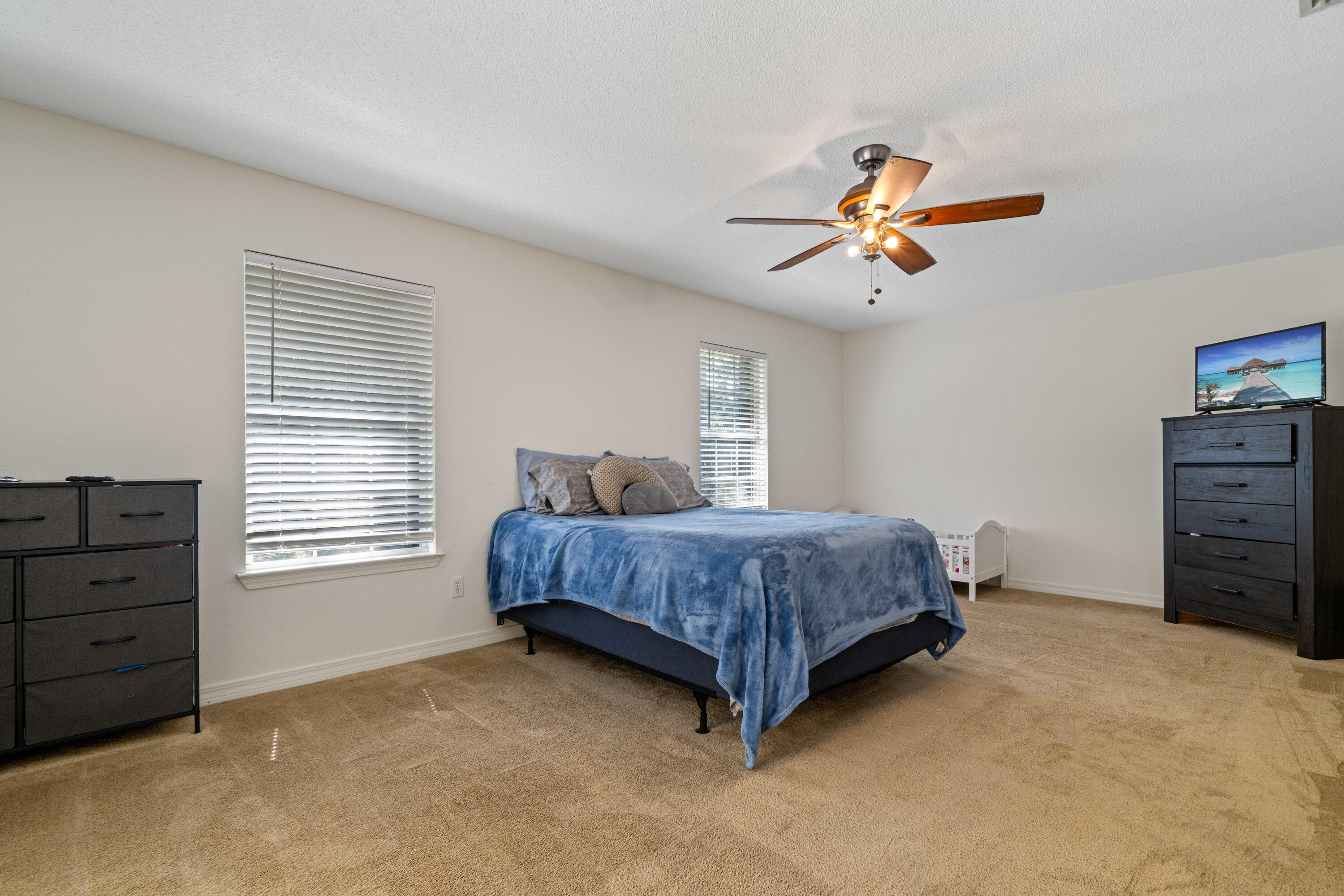 7199 Riverview Road Navarre, FL 32566 - Photo 9 of 15 a bedroom with a bed and a chandelier