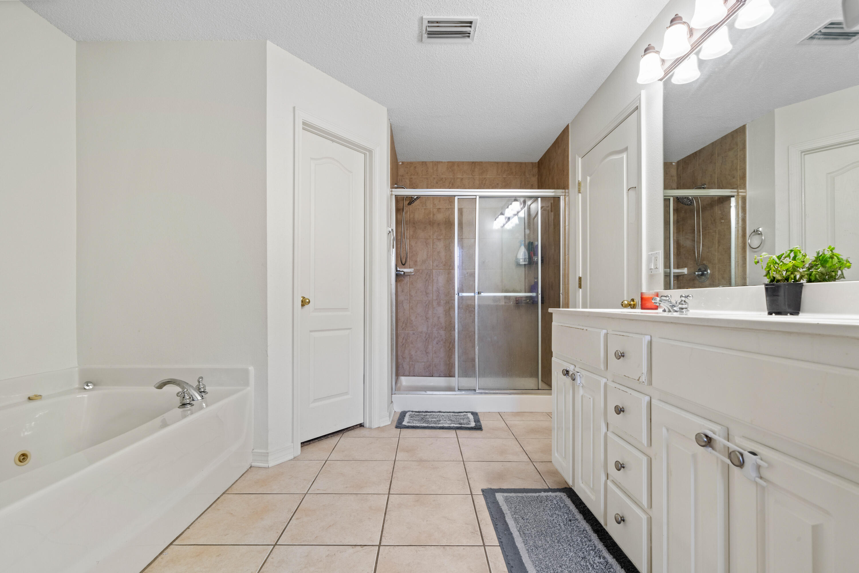 7199 Riverview Road Navarre, FL 32566 - Photo 10 of 15 a spacious bathroom with a tub shower and a sink