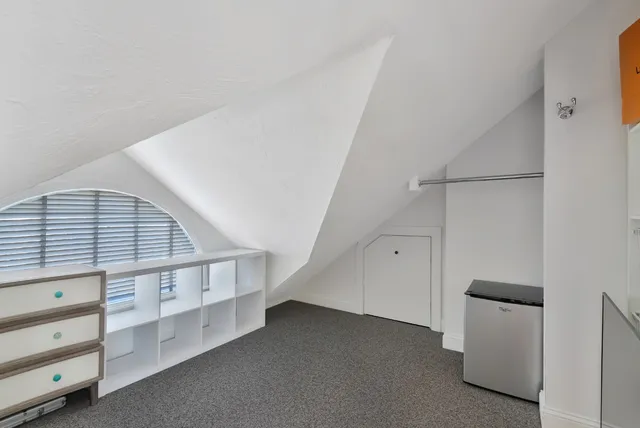 a living room with furniture and stairs