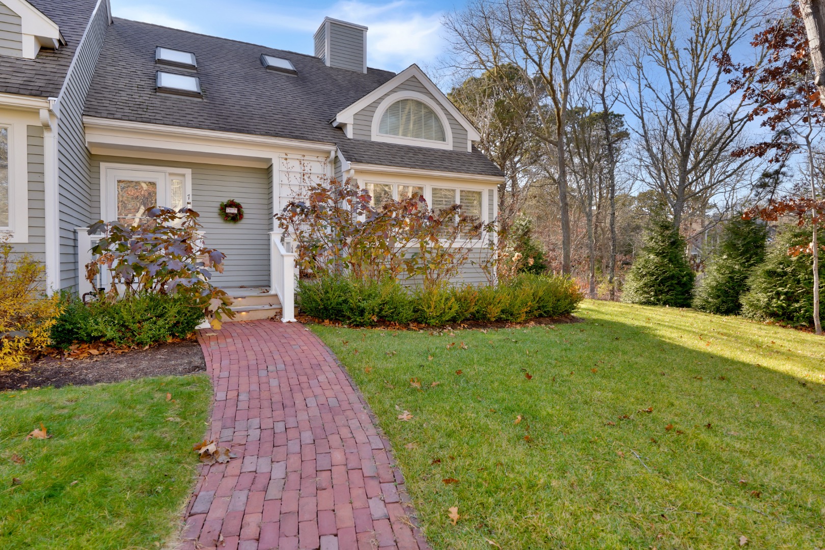 7 Meetinghouse Village Way Edgartown, MA 02539 - Photo 2 of 27 a front view of a house with garden