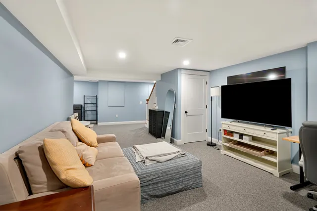 a large bedroom with a bed and a desk