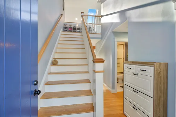 a view of entryway and hall with wooden floor