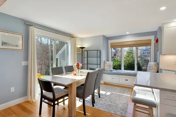 a dining room with furniture a chandelier and wooden floor