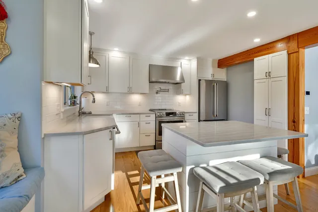 a kitchen with stainless steel appliances granite countertop a sink refrigerator and microwave