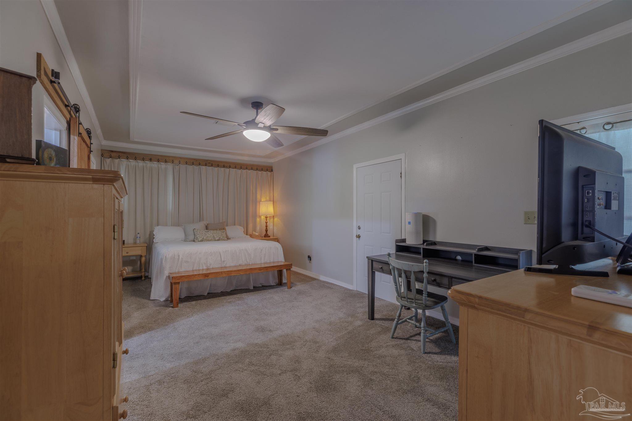 5049 Guernsey Road Pace, FL 32571 - Photo 36 of 61 a bedroom with a bed and a table in it