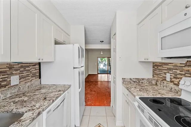 a kitchen with a stove and a refrigerator