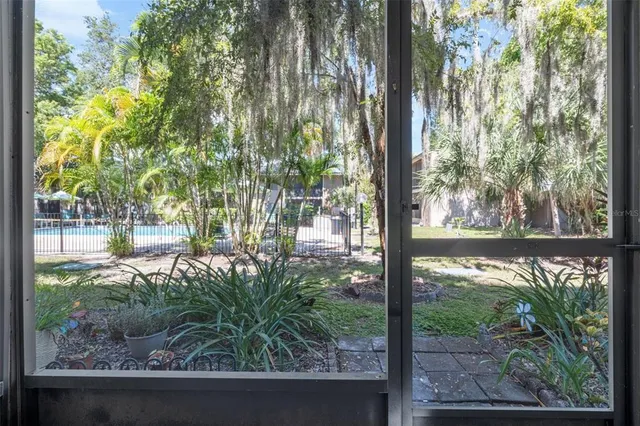 a view of a house with a yard and potted plants