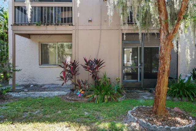 a view of a house with a small yard and fence